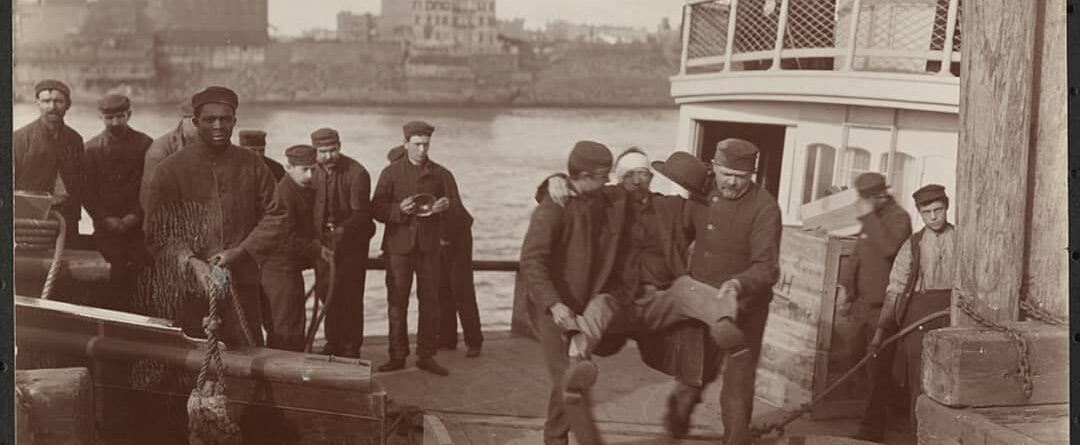 Two men carrying a patient off the ferry to the pier on the island in the mid 18…